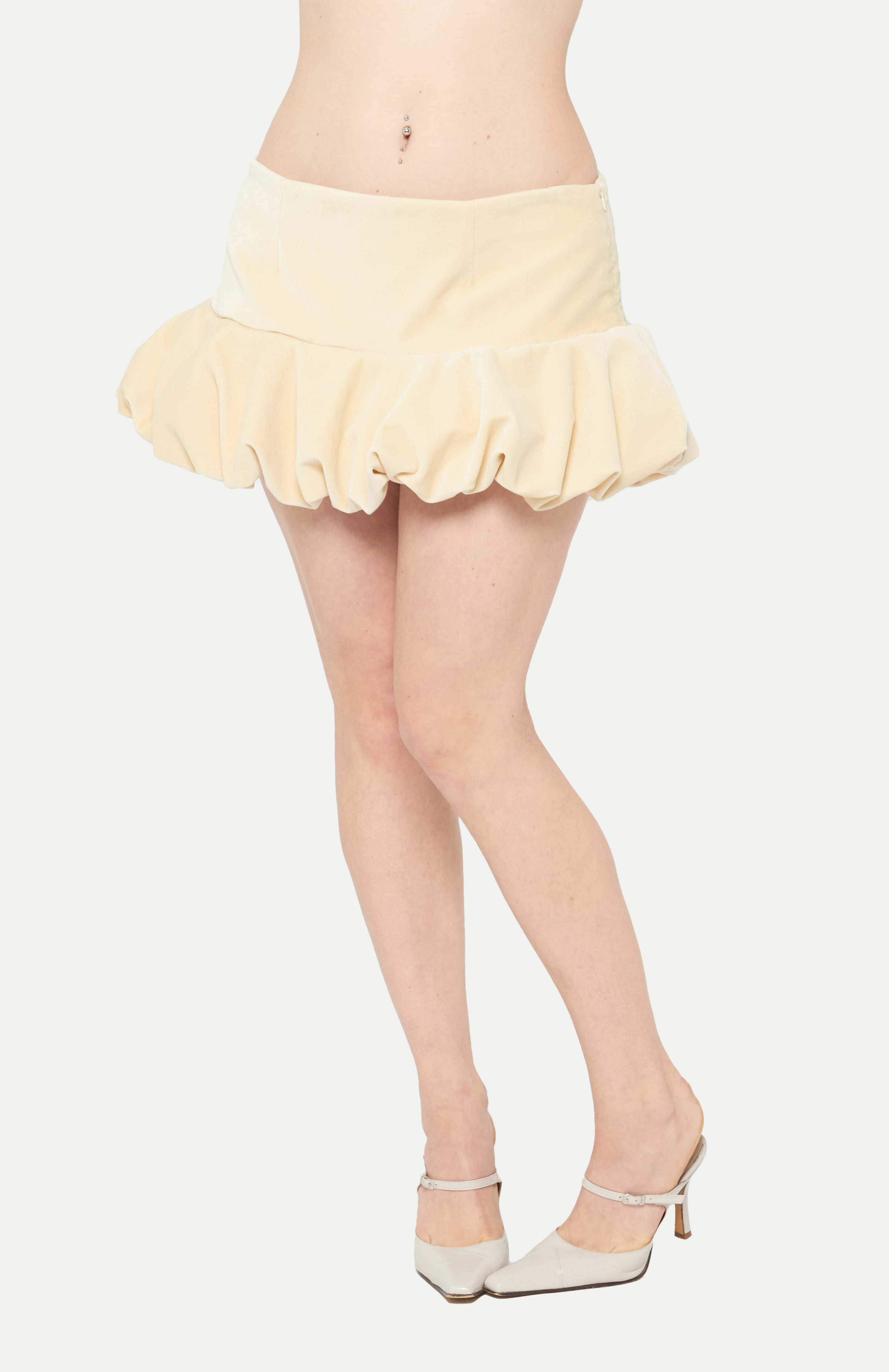 Maroske Peech A flirty playful bubble mid waisted mini skirt that salutes the fashion trends of the 1980s. This mid rise puffball style is created with a crinoline inner foundation to hold its balloon-like shape. A wonderful way to add volume to a silhouette.