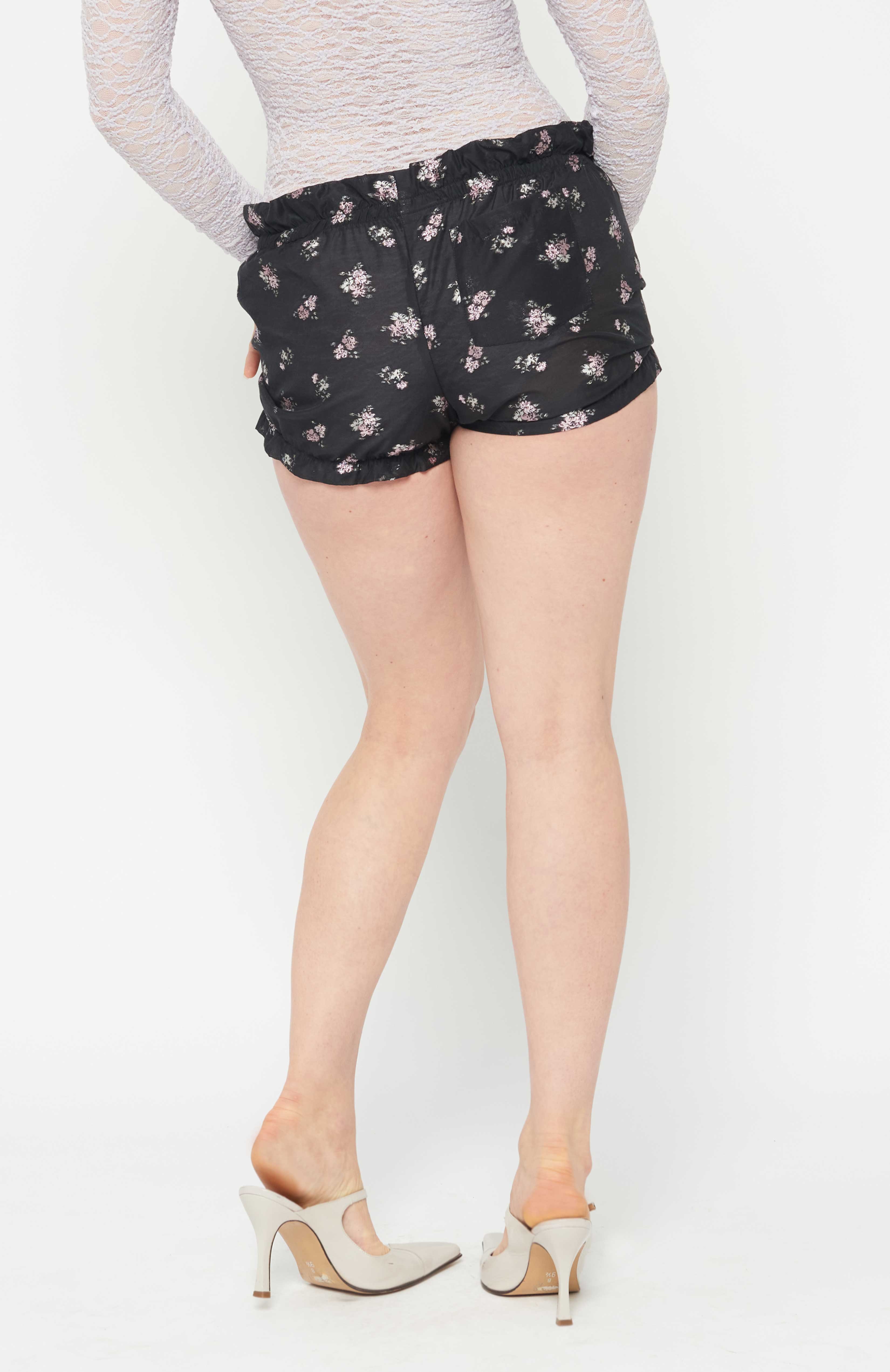 Maroske Peech A high waisted cotton playful bloomer for special occasions. Featuring a soft stretchy ruffle waistband and hem. Fashioned in a light weight woven jacquard with a flattering detailed pink metallic floral. A handy patch pocket is positioned on back. Can be easily styled under short skirts, over leggings for modesty and alternatively on its own during the warmer months.
