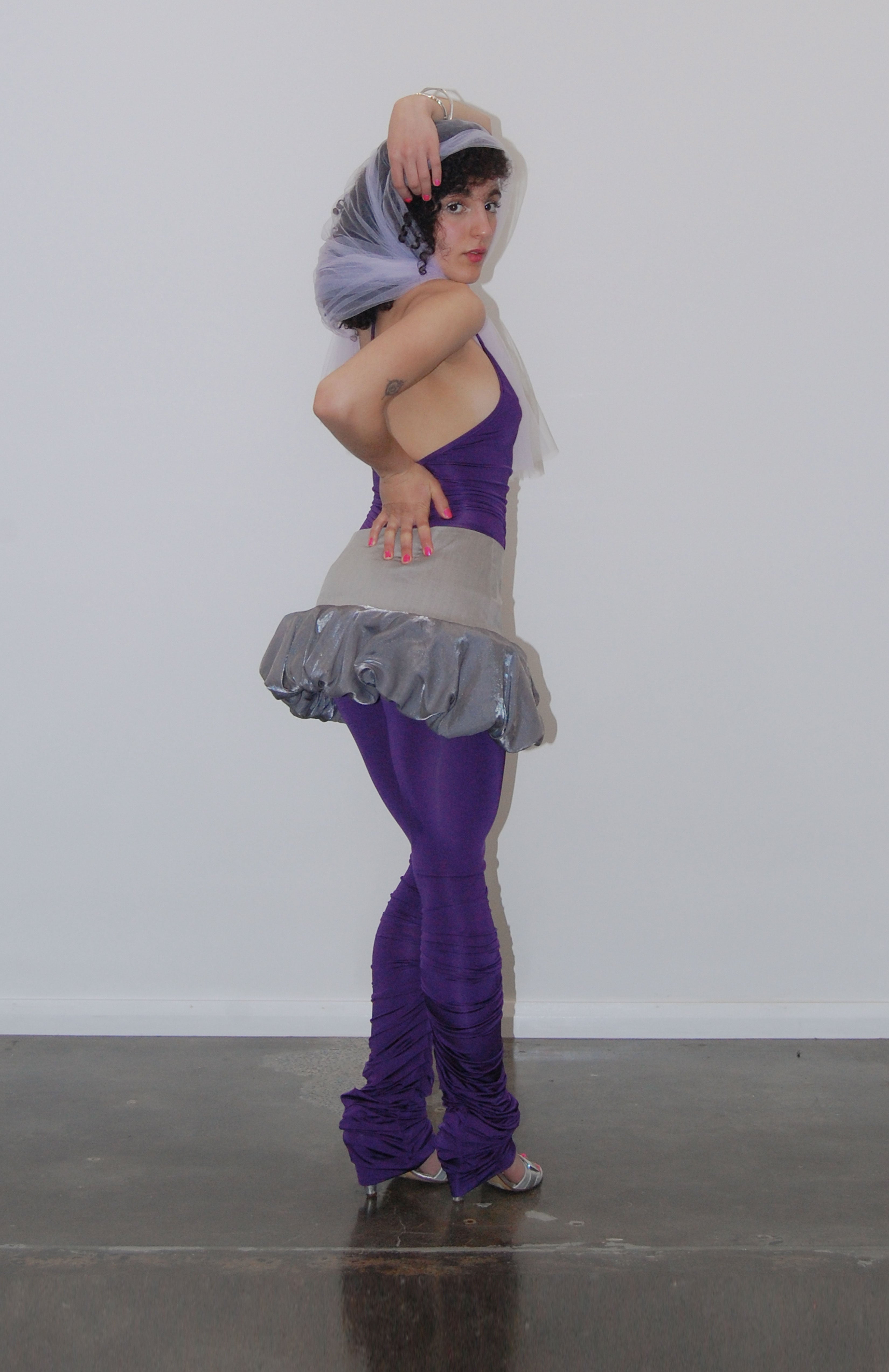 mid waisted mini skirt that salutes the fashion trends of the 1980s. This mid rise puffball style is created with a crinoline inner foundation to hold its balloon-like shape. A wonderful way to add volume to a silhouette.