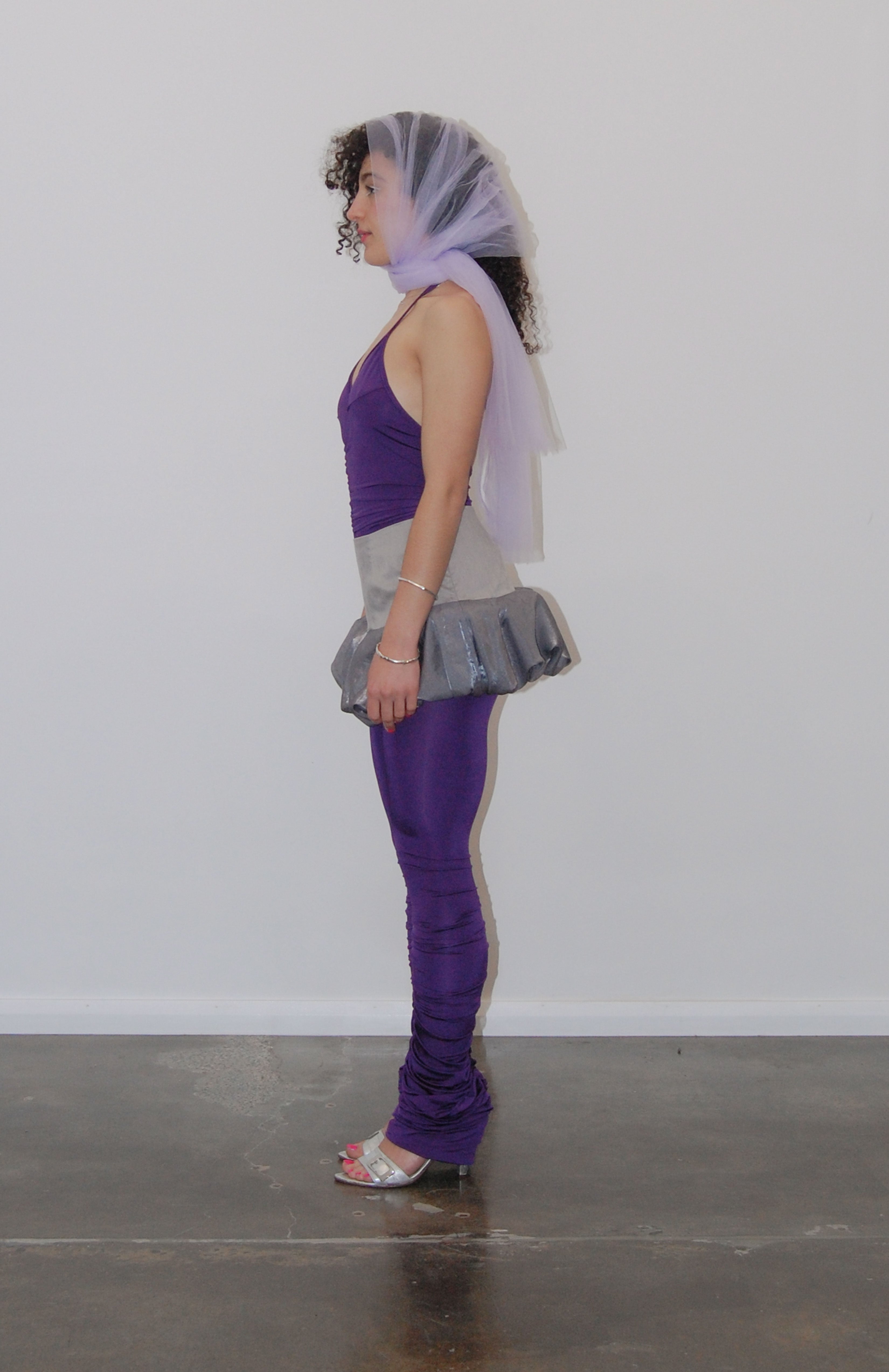 mid waisted mini skirt that salutes the fashion trends of the 1980s. This mid rise puffball style is created with a crinoline inner foundation to hold its balloon-like shape. A wonderful way to add volume to a silhouette.