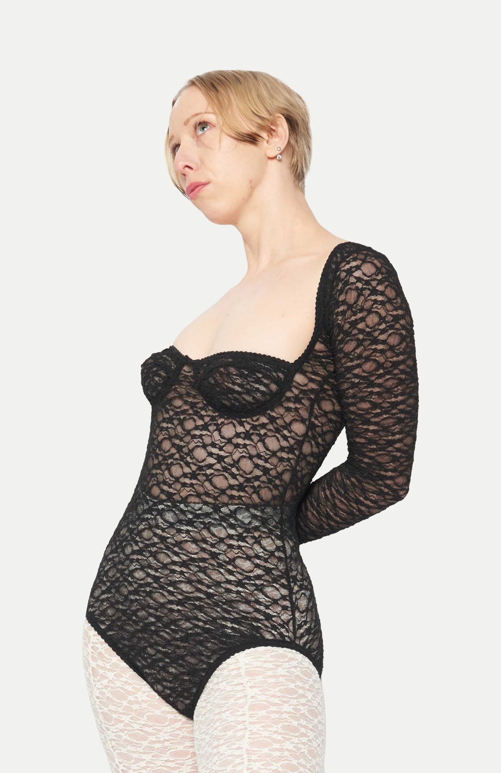 maroske peech A reprise of our signature stretch soft cup leotard in stunning black lace. Features a snap opening at gusset for ease wearer and zig-zag decorative stitching with a scalloped elastic detail.