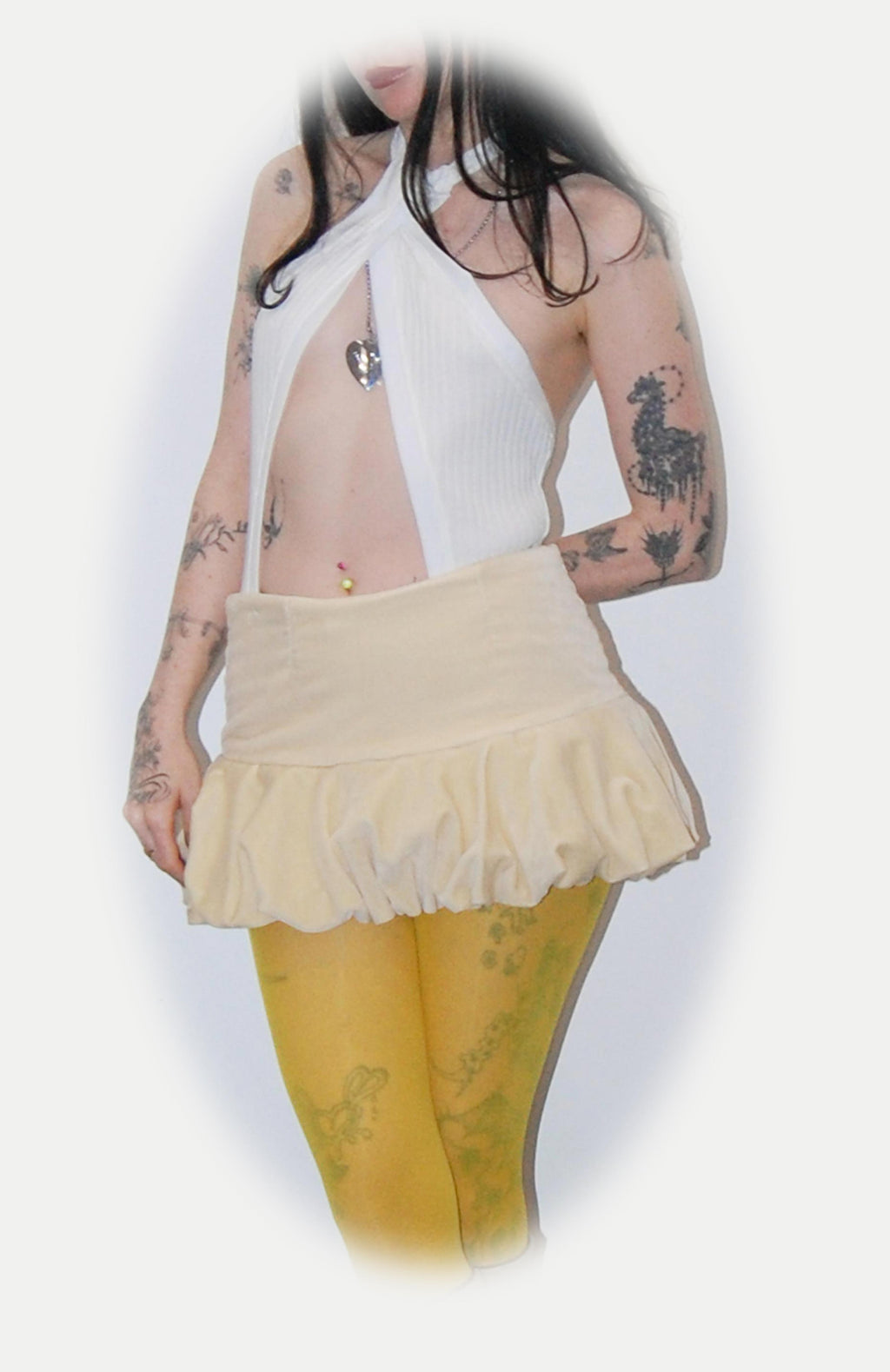 Maroske Peech A flirty playful bubble mid waisted mini skirt that salutes the fashion trends of the 1980s. This mid rise puffball style is created with a crinoline inner foundation to hold its balloon-like shape. A wonderful way to add volume to a silhouette