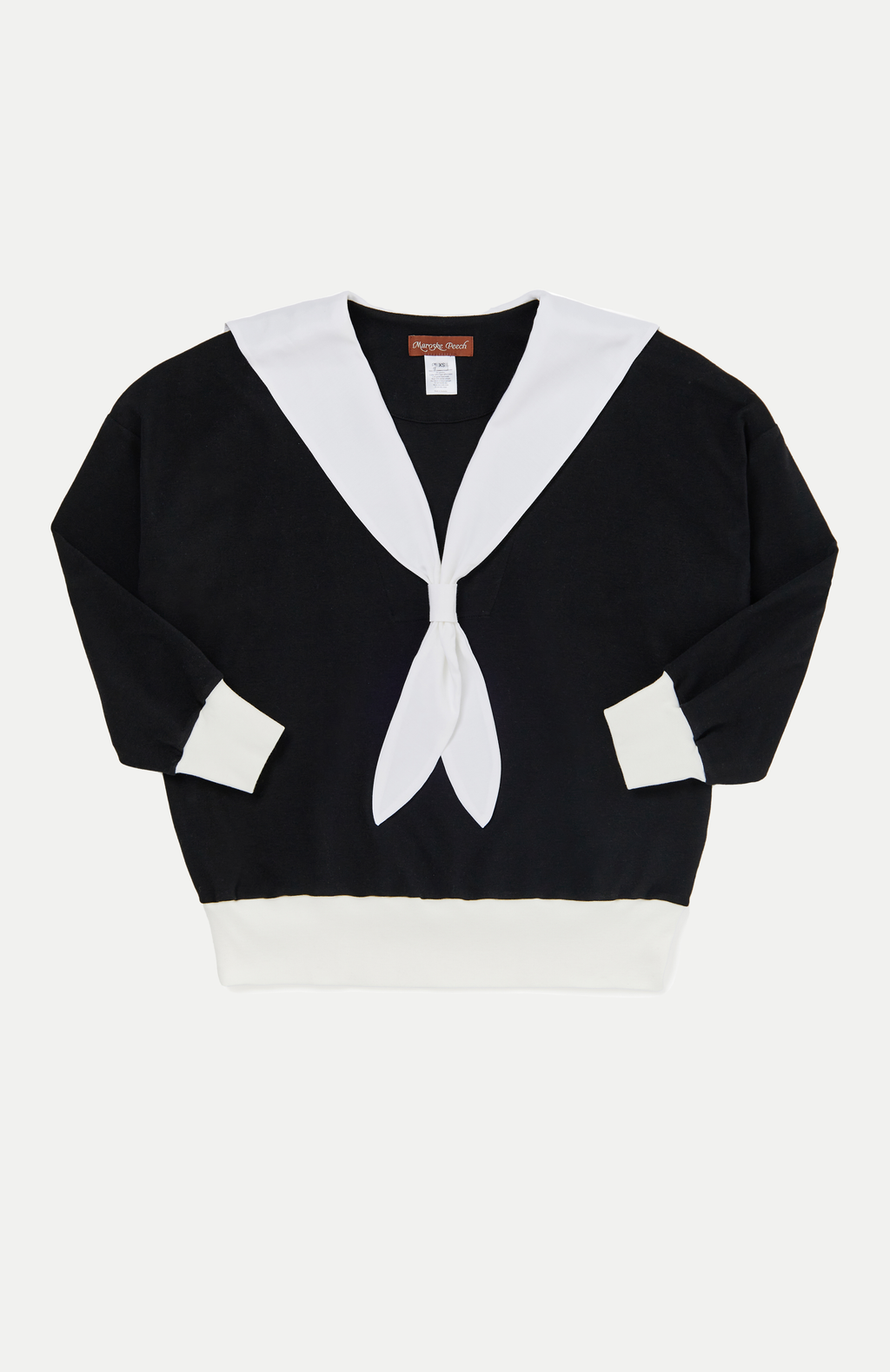 An oversized soft knit black jersey sweater with romantic white V-neck sailor collar. Features complimentary white rib accent cuffs and hem. This cosy style is a sophisticated alternative to a hoodie that can be easily dressed up or down. Perfect for provoking a glamorous yet bitter sweet adventure.