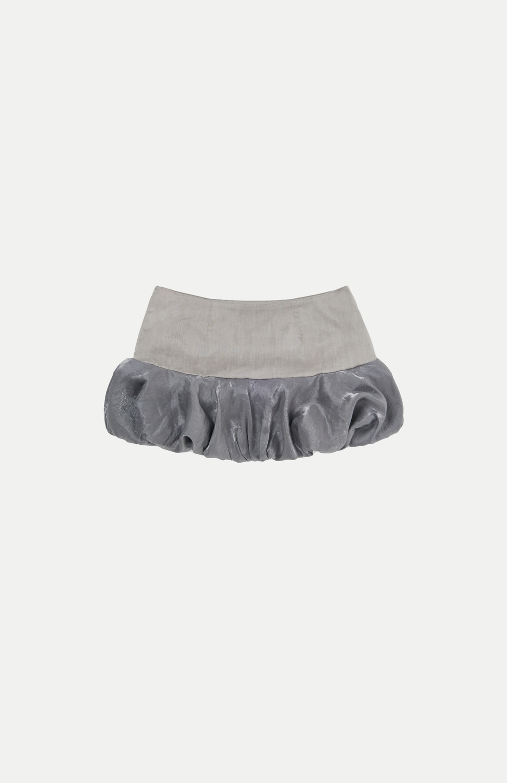 mid waisted mini skirt that salutes the fashion trends of the 1980s. This mid rise puffball style is created with a crinoline inner foundation to hold its balloon-like shape. A wonderful way to add volume to a silhouette.