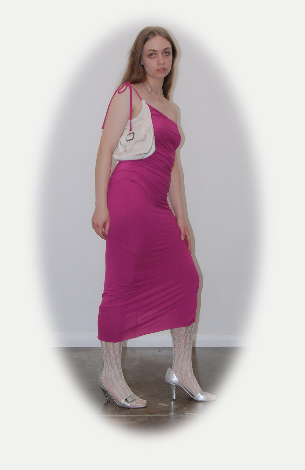 Mid length maxi dress in fuchsia jersey with attached Navy purse pocket. Features, flattering pleats from underarm to the high hip Thigh high slit and adjustable tie spaghetti strap. fully lined with square buckle and magnetic button.