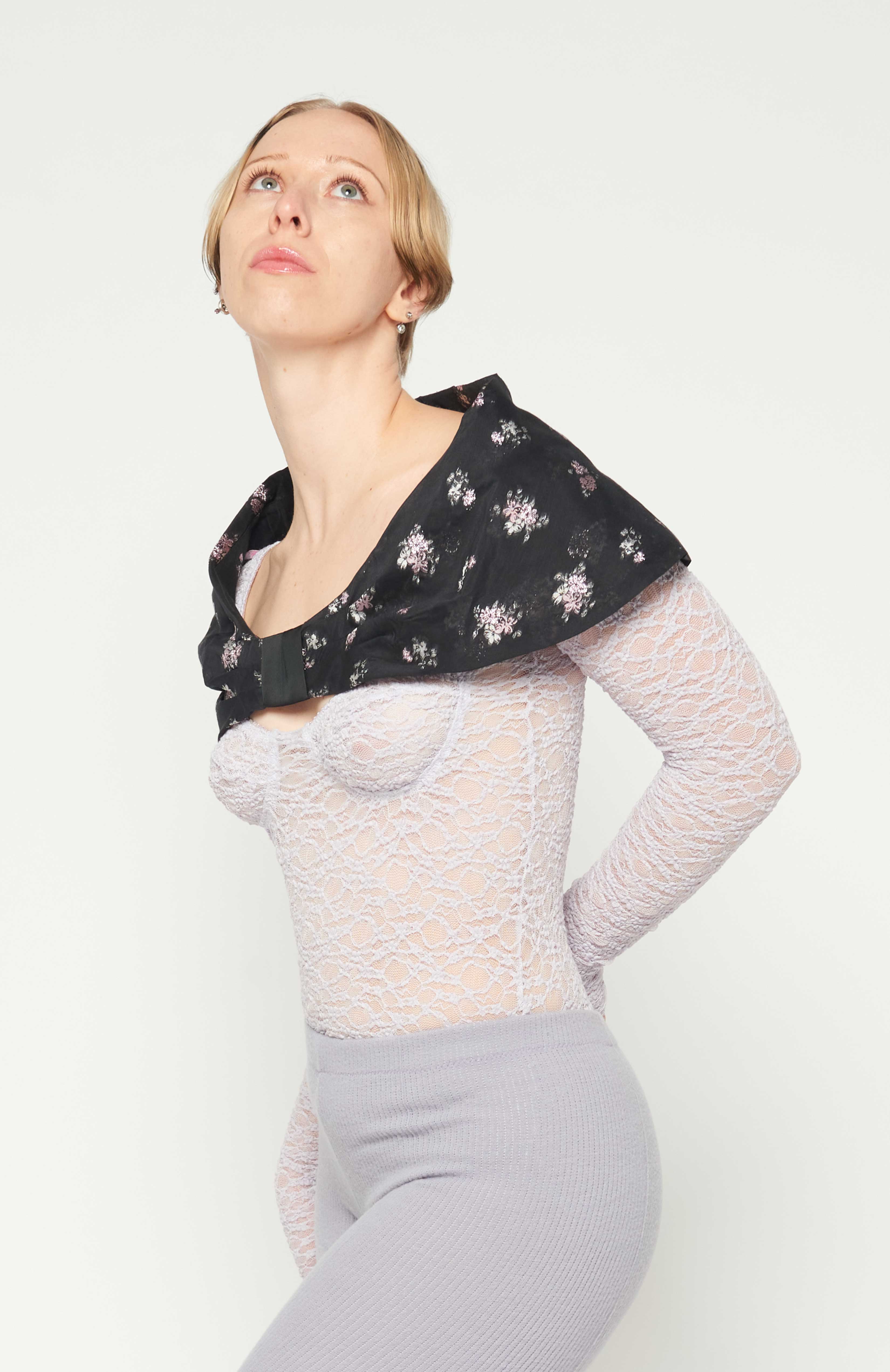 Maroske Peech, A stylish cape-like black floral bow collar. Sits on your shoulders to frame the neck and face. Fashioned in a light weight woven jacquard with a flattering detailed pink metallic floral. A perfect way to create a dramatic frame-like allure to elevate any outfit when your presence is required.