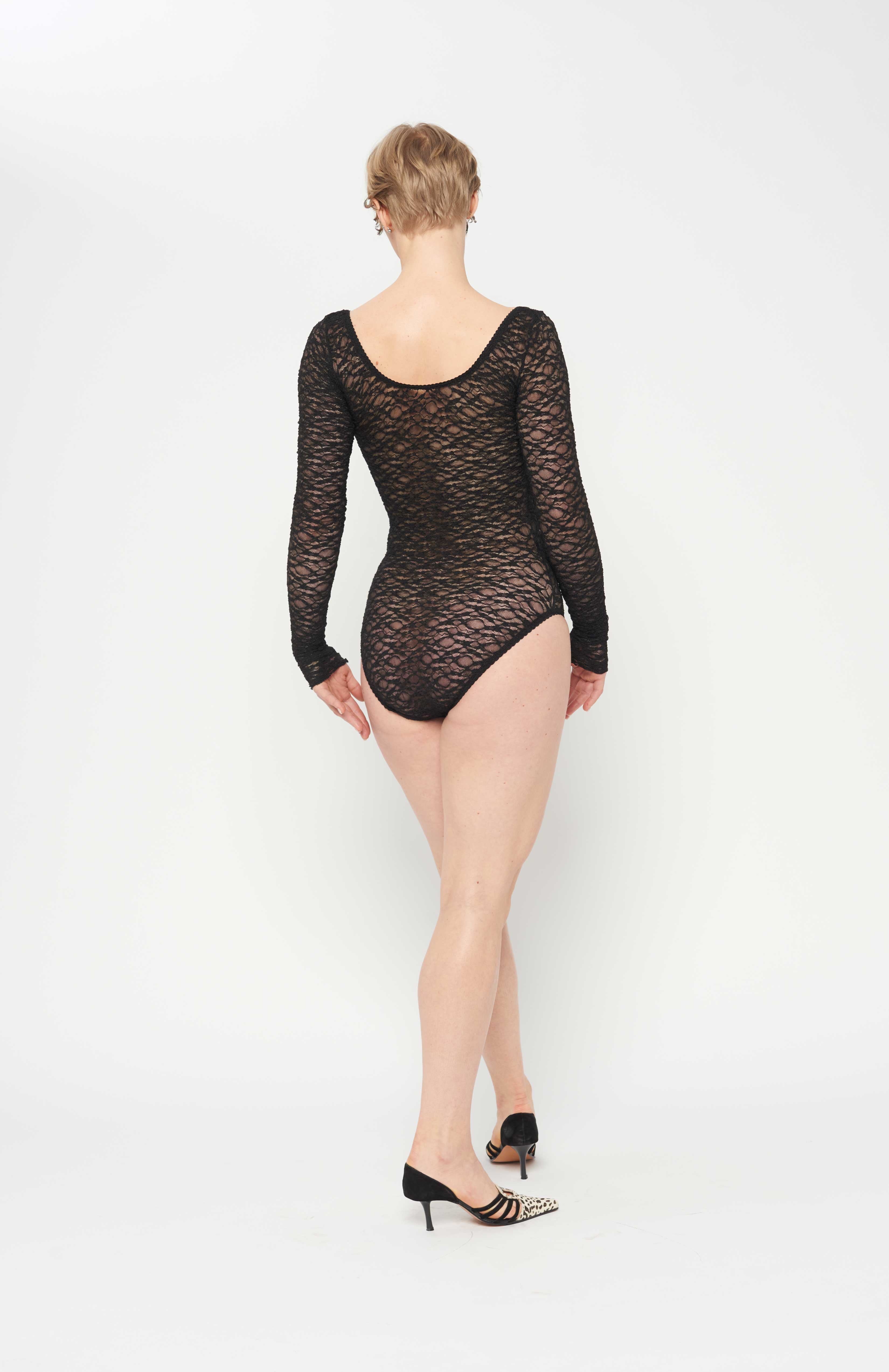 maroske peech A reprise of our signature stretch soft cup leotard in stunning black lace. Features a snap opening at gusset for ease wearer and zig-zag decorative stitching with a scalloped elastic detail.