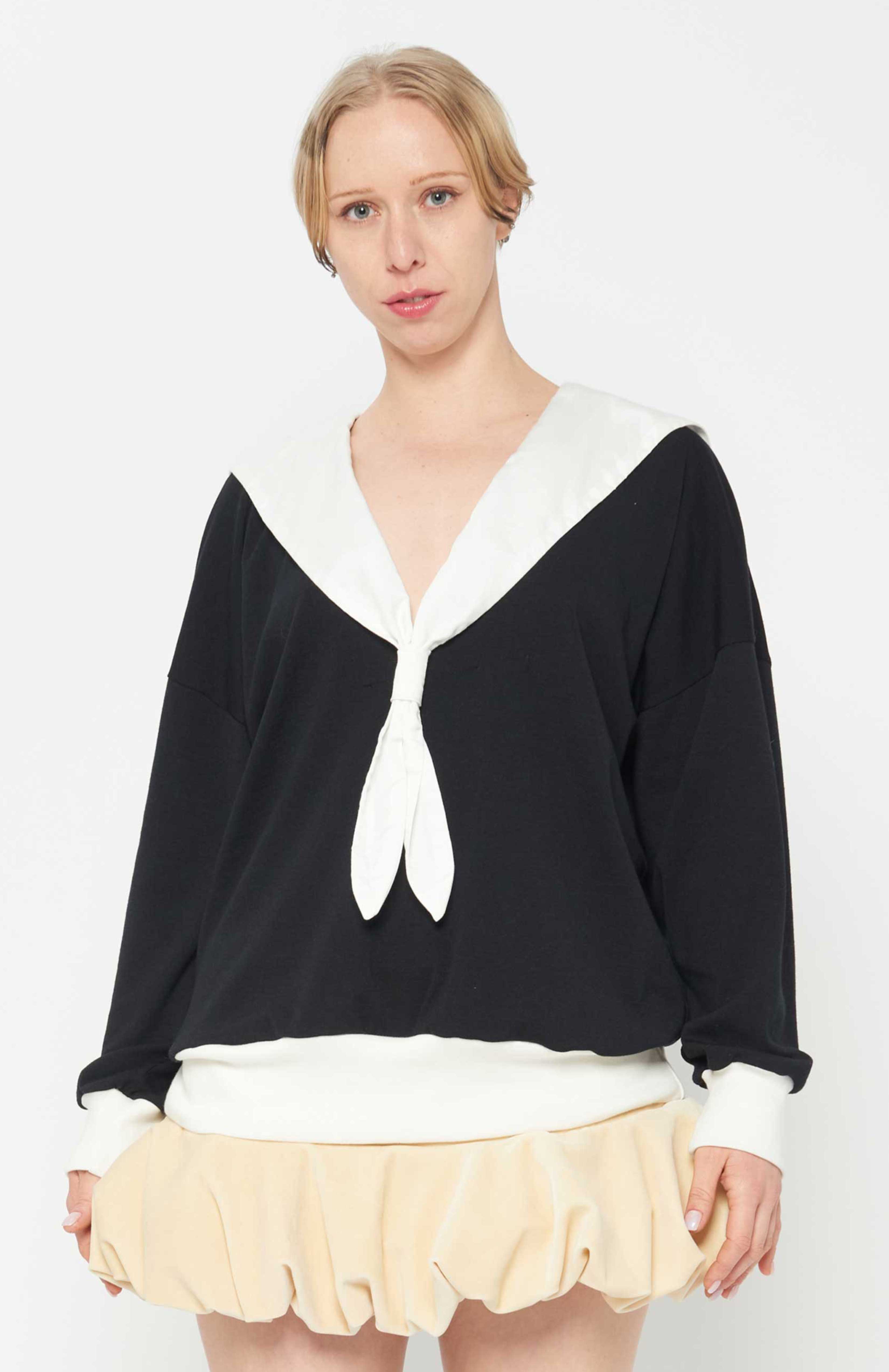 Maroske Peech Oversized soft knit black jersey sweater with romantic white V-neckline sailor collar. features complimentary white rib accent cuffs and hem. This cosy style is a glamorous winter alternative that can be easily dressed up or down. Perfect for provoking a glamorous yet bitter sweat adventure.