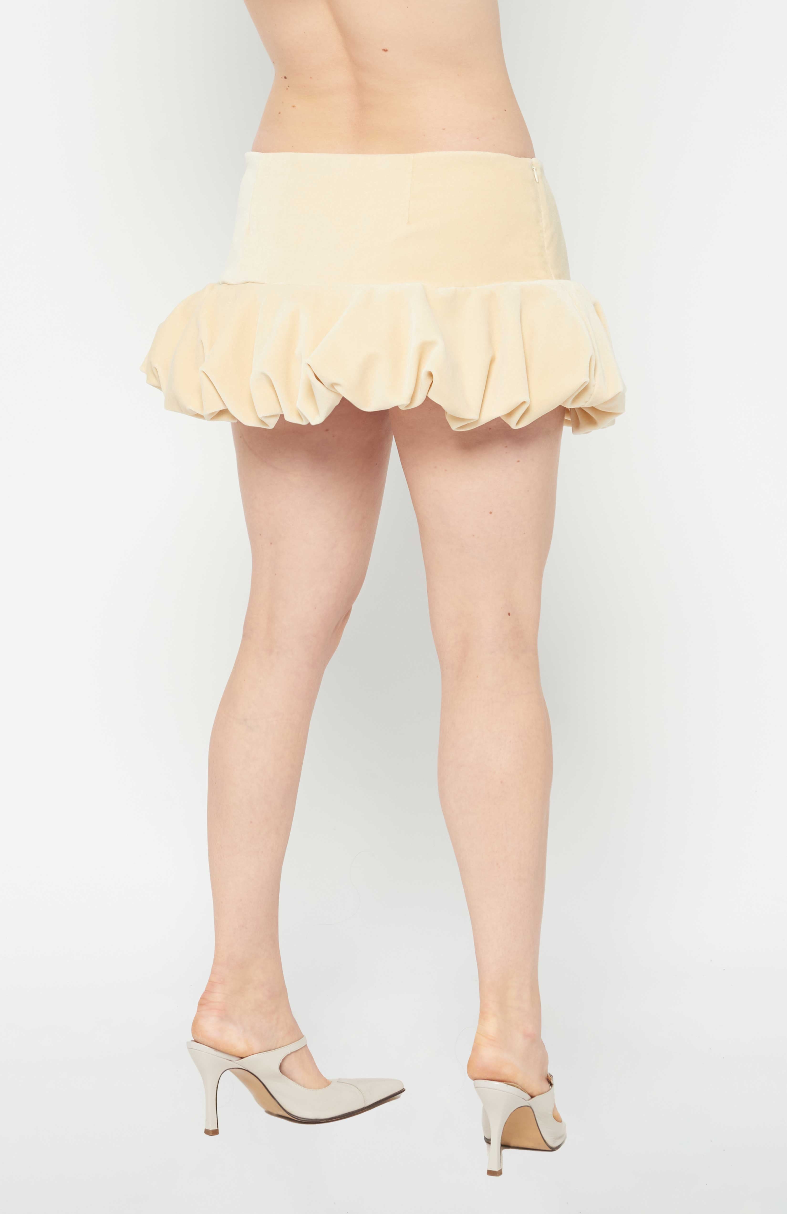 A flirty playful bubble mid waisted mini skirt that salutes the fashion trends of the 1980s. This mid rise puffball style is created with a crinoline inner foundation to hold its balloon-like shape. A wonderful way to add volume to a silhouette.