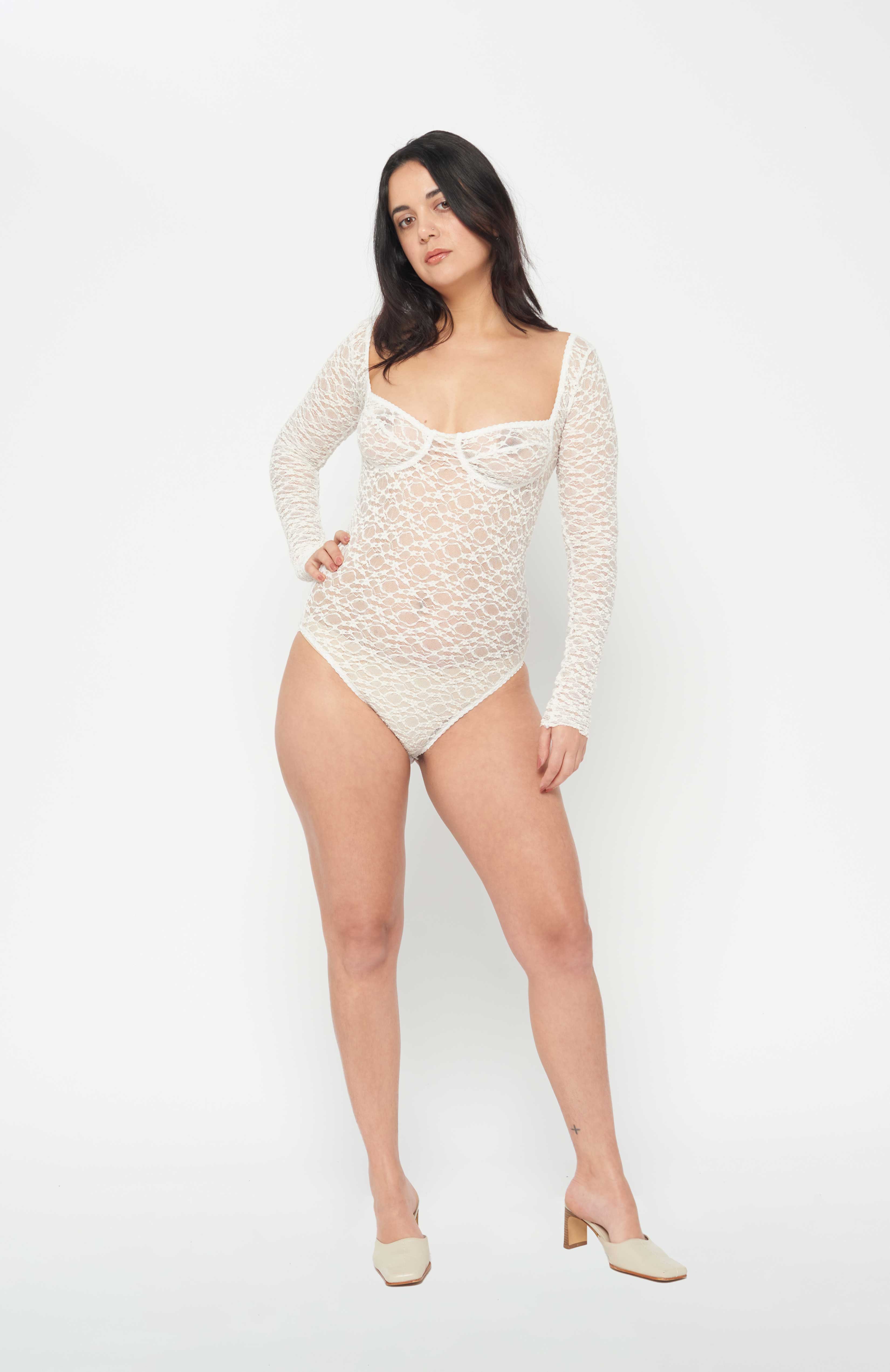 Maroske Peech A reprise of our signature stretch soft cup leotard in stunning ivory lace. Features a snap opening at gusset for ease wearer and zig-zag decorative stitching with a scalloped elastic detail. 