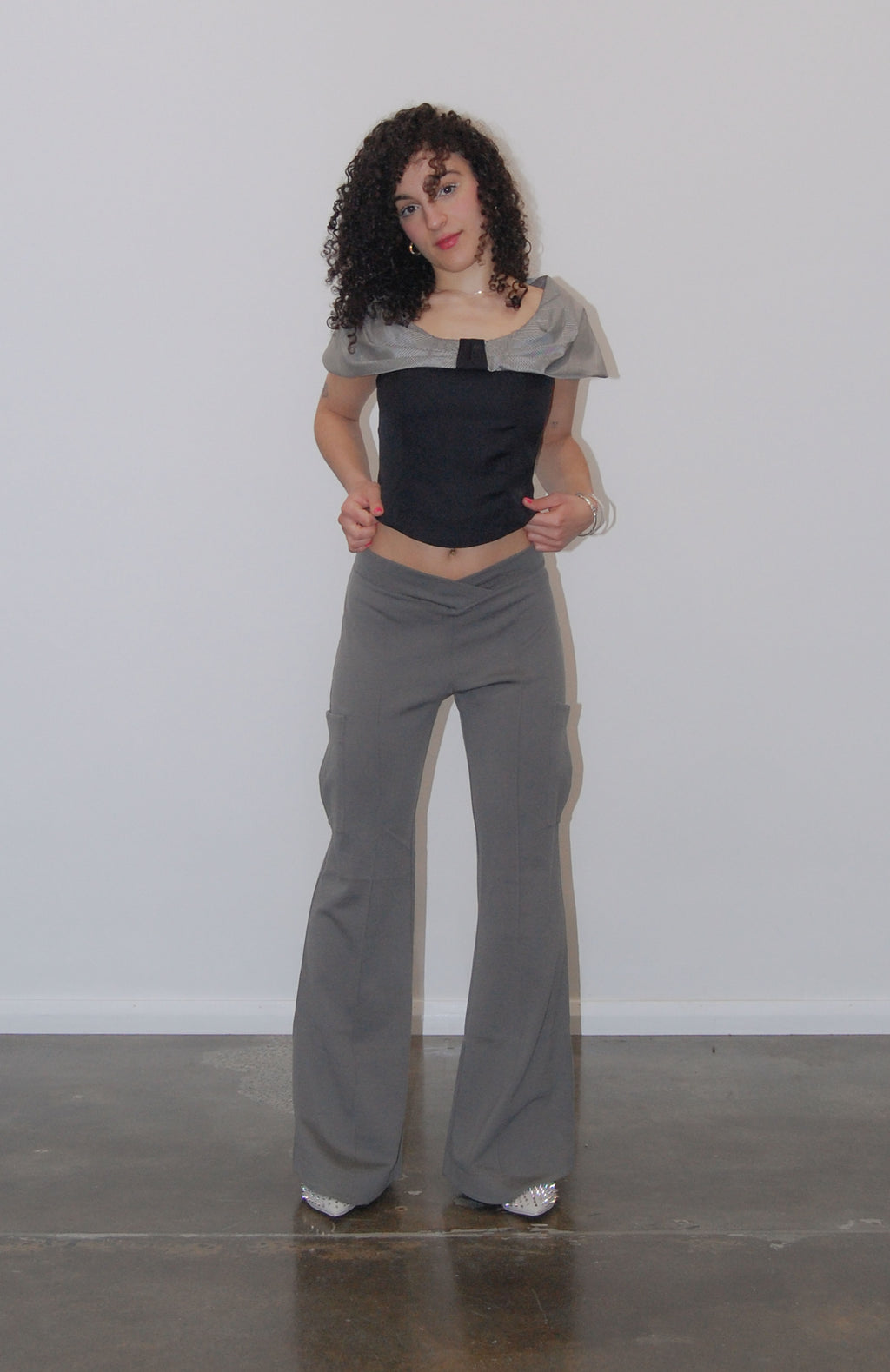 Relaxed cargo track pant with a V-shaped elasticated waist. 3D saddle pockets on side of leg and back patch pockets for extra added storage. Pin tucks run down the front and back of the legs to enhance length. Finished with a flared leg and shaped hem. Can be dressed up or down.