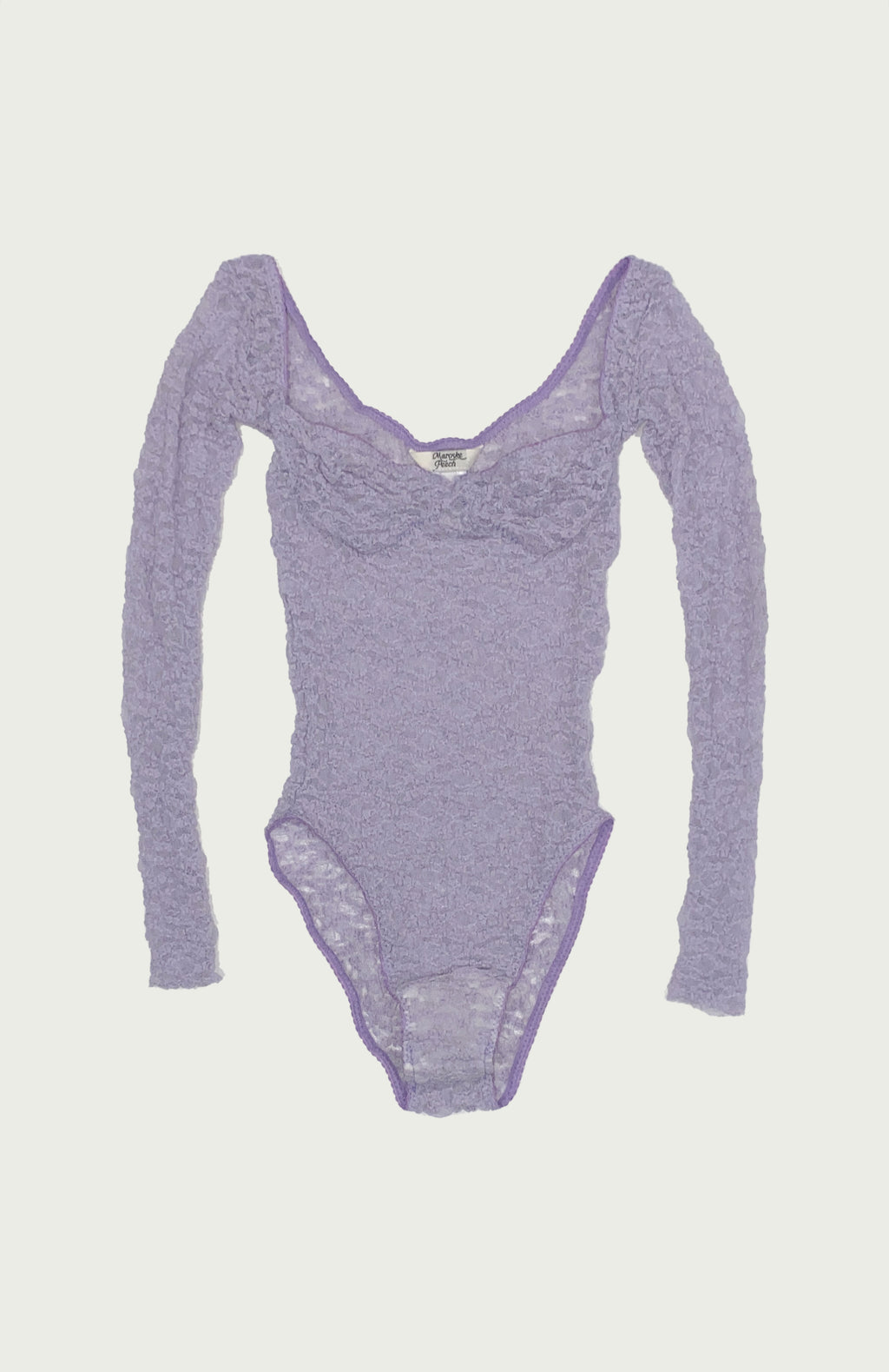 Maroske Peech A reprise of our signature stretch soft cup leotard in stunning lilac lace. Features a snap opening at gusset for ease wearer and zig-zag decorative stitching with a scalloped elastic detail.