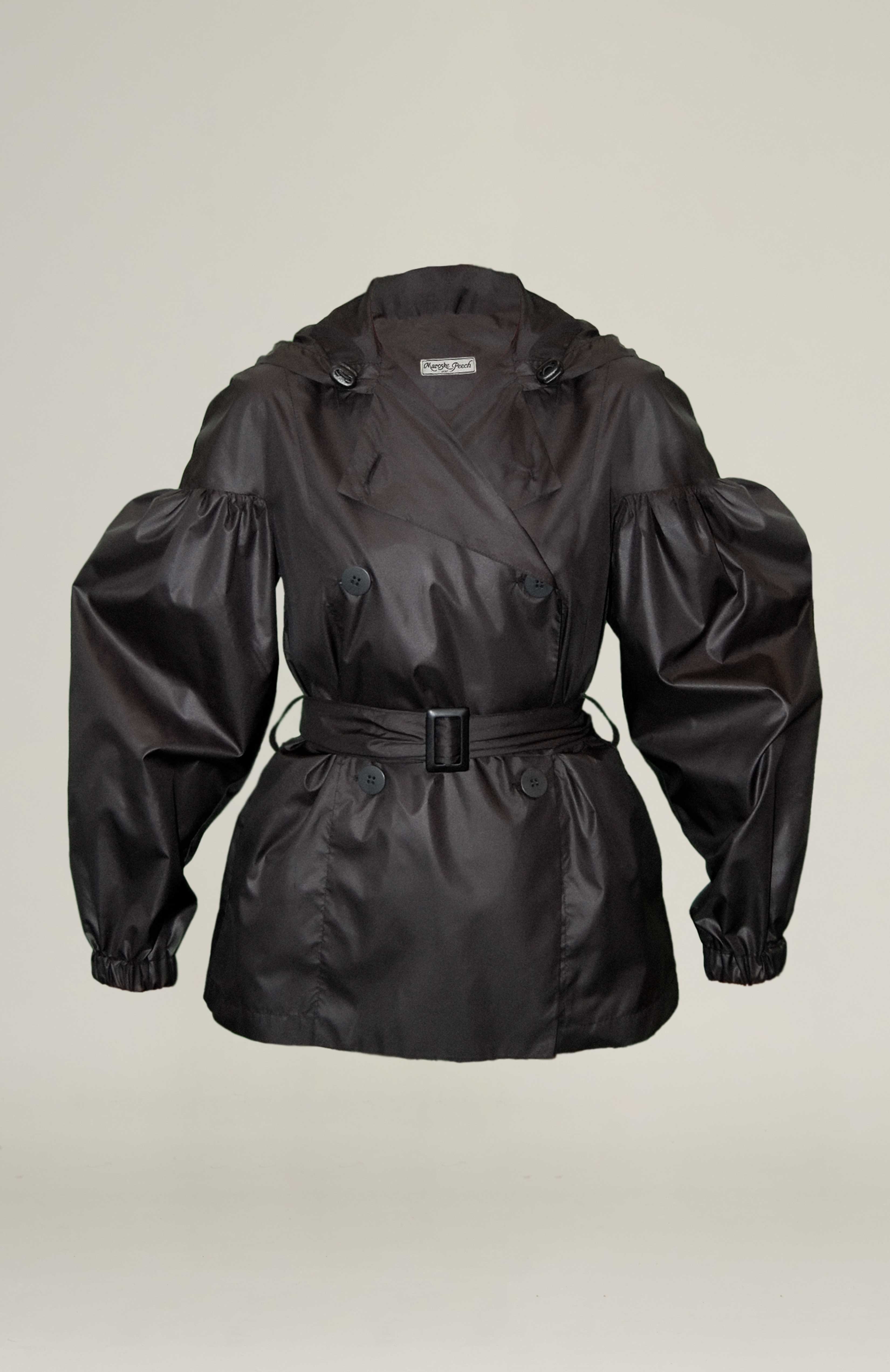 Light weight double breasted trench jacket with dramatic gathered sleeves. Adjustable pull string hood and elasticated cuffs. Side seam pockets and belt loops. Comes with waist belt fasten
