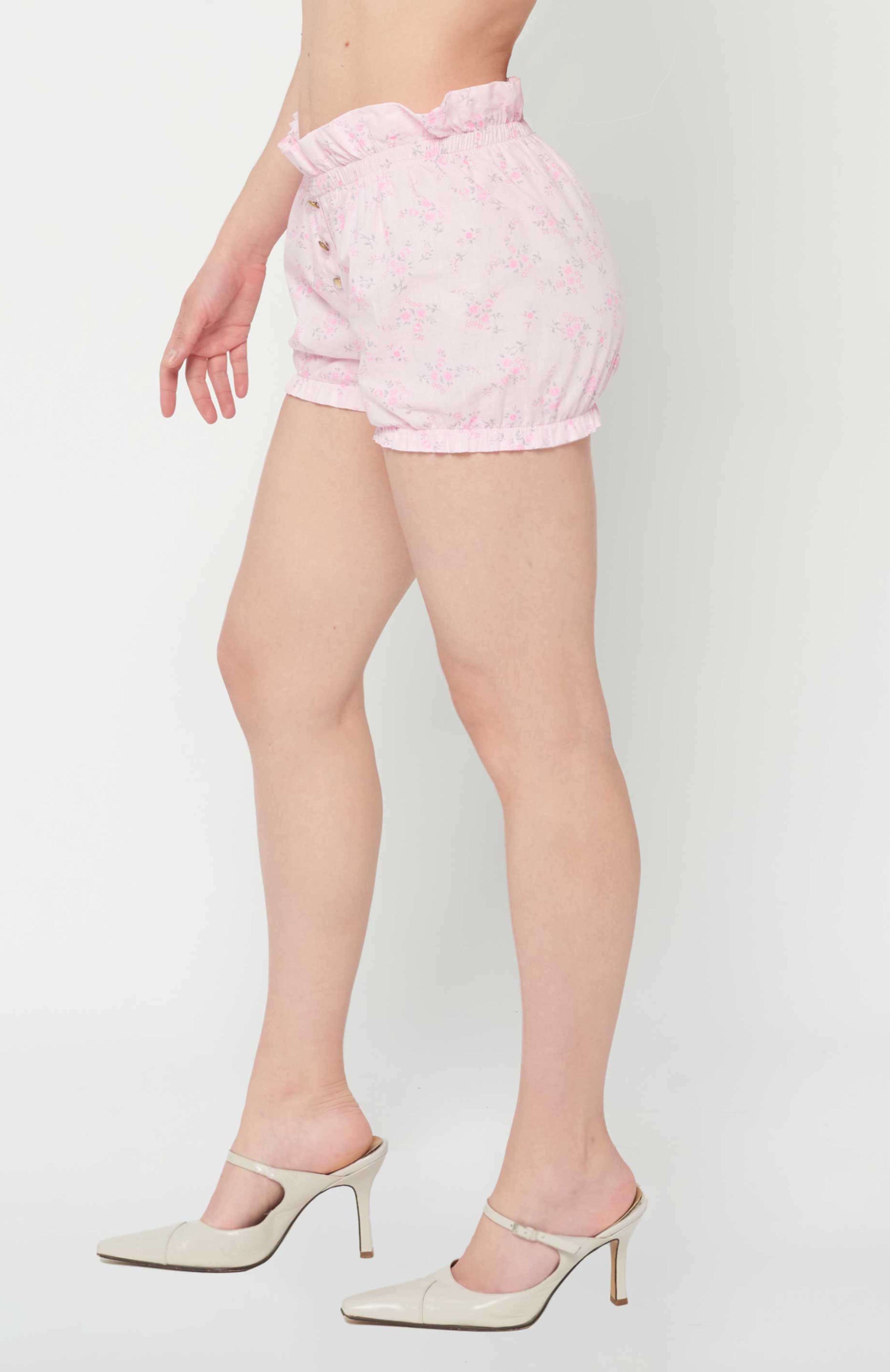 Maroske Peech high waisted cotton playful bloomer for special occasions. Featuring a soft stretchy ruffle waistband and hem. Fashioned in a light weight woven pink floral. A handy patch pocket is positioned on back. Can be easily styled under short skirts, over leggings for modesty and alternatively on its own during the warmer months.